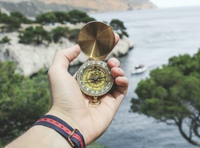 Person Holding Compass