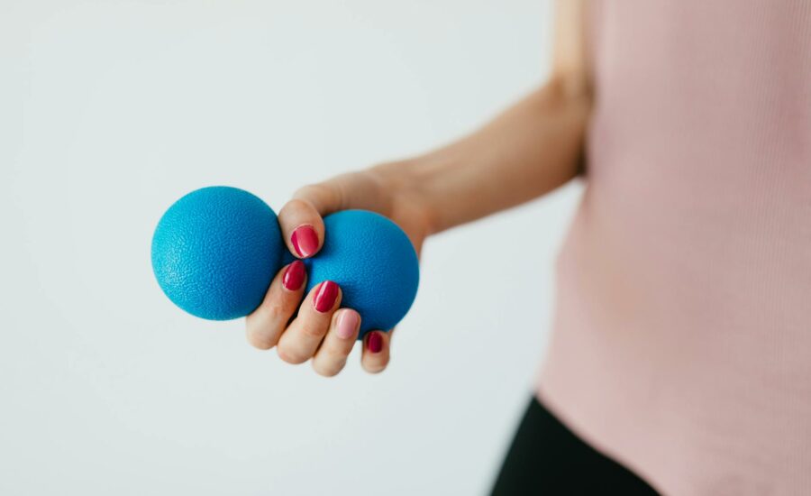 Faceless young woman with stress ball on white background